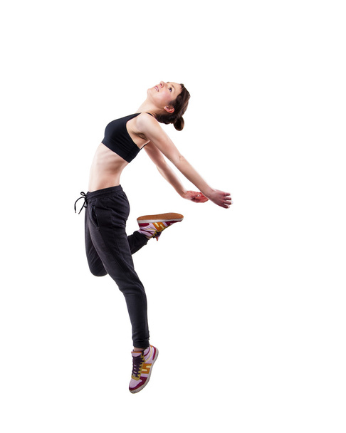 μοντέρνο στυλ χορεύτρια εμπιστοσύνης στον αέρα σε φόντο στούντιο - Φωτογραφία, εικόνα