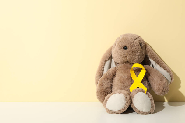 A soft toy bunny with a yellow ribbon - Photo, Image