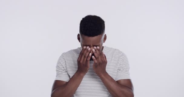 Headache, stress or fatigue with black man in studio on white background for mental health and anxiety. Portrait, burnout or pain with young person touching temples for depression and psychology. - Footage, Video