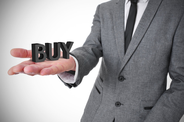 Бізнесмен зі словом купити в руці
 - Фото, зображення