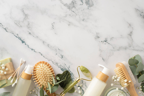 Hygienic beauty arrangement on natural stone. Gua sha tools, cream, serum, handmade soap, bamboo hairbrush, gypsophila, eucalyptus and more. Perfect for promoting your brand or message - Photo, Image