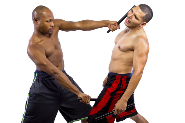 Martial artists sparring with Kali Escrima - 写真・画像