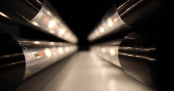 Long led lamps with warm lighting in form of tunnel in dark premises. Современное питание в переносном виде. Использование света для освещения проживания - Кадры, видео