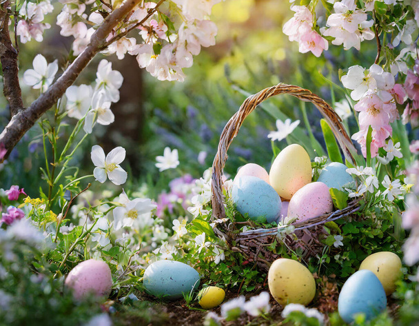 In this delightful Easter scene, vibrant eggs adorned in various hues create a kaleidoscope of colors, bringing the spirit of celebration to life. The sun bathes the scene in warm rays, casting a golden glow on the lush green grass below. The air is  - Photo, Image
