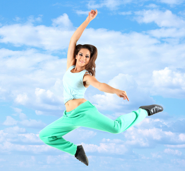 Jumping woman on sky background - Photo, Image