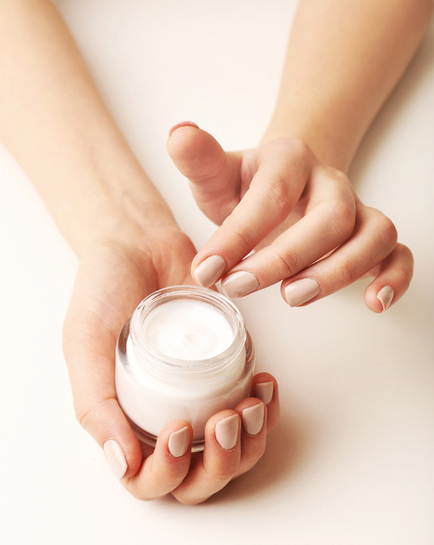 Female hands holding jar of cream isolated on white - Foto, imagen