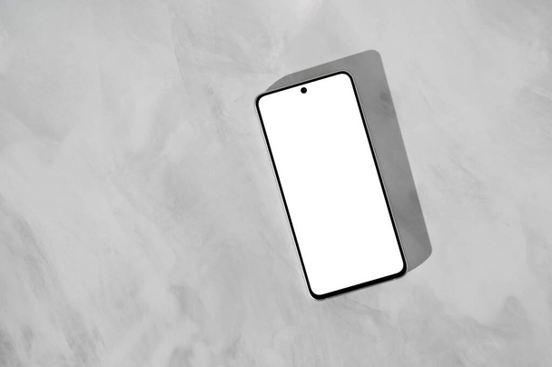 Minimal business branding template, λευκό κενό κινητό τηλέφωνο οθόνη mockup με αντίγραφο χώρου σε γκρι μαρμάρινο τραπέζι πάνω φόντο, επίπεδη lay. - Φωτογραφία, εικόνα