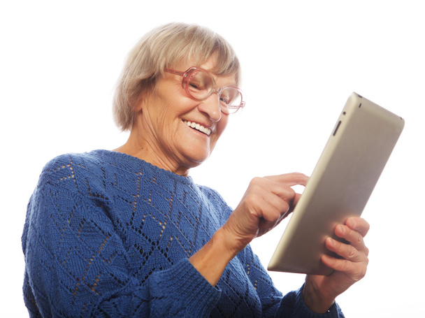 Senior happy woman using ipad - Foto, afbeelding