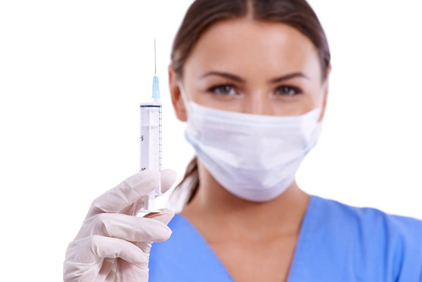 Woman, portrait and doctor with face mask or needle for protection, health and safety on a white studio background. Female person, surgeon or medical nurse with syringe for vaccination or anesthetic. - Photo, Image
