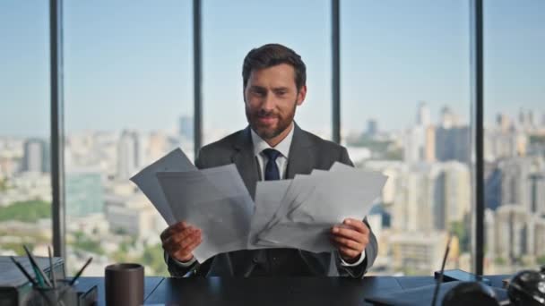 Happy businessman throwing documents enjoying success. Smiling corporate manager read sales contract rejoicing at office desk. Excited mature man specialist celebrating triumph financial achievement - Footage, Video