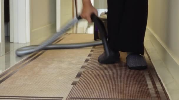 Woman vacuuming the corridor floor carpet . - Footage, Video