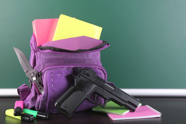 Gun in school backpack - Zdjęcie, obraz