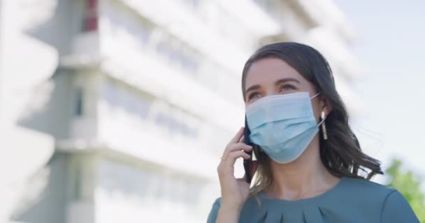 Woman, phone call and commute to work, mask and city for office job, conversation and networking. Female person, pandemic or virus protection for workers, health or safety from sickness or infection. - Footage, Video