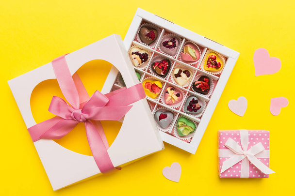 Valentine day composition: sweet candy, with gift boxes with bow and red felt hearts, photo template, background. Top View with copy space. - Photo, Image