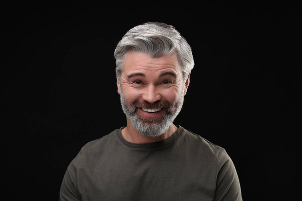 Personality concept. Portrait of happy man on black background - Zdjęcie, obraz
