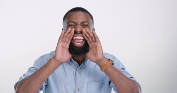 News, announcement and face of black man shouting in studio with info on white background. Voice, portrait and African male model with screaming emoji for warning, attention and message broadcast. - Footage, Video