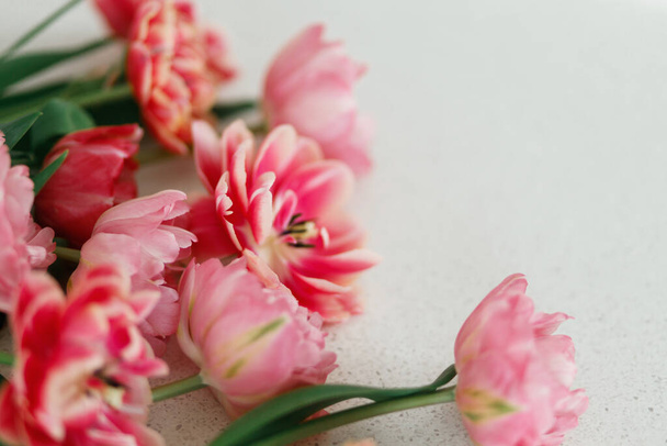 Krásné tulipány na šedém kamenném pozadí, prostor pro text. Stylová květinová kytice. Šťastný Valentýn a šťastný Den matek. Křehké růžové a červené květy tapety - Fotografie, Obrázek