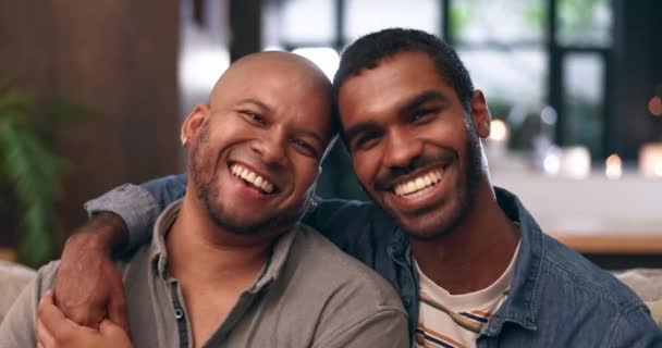 Home, gay couple and face with laugh, smile and love with bonding and hug in a living room. Partner, sofa and lgbt pride with marriage together in happy house with queer romance and relationship care. - Footage, Video