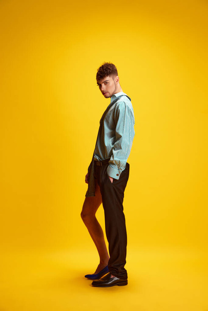 Full length portrait of young man with male and female halved appearance showing gender fluidity and progressive fashion choices. Concept of self-expression, style, beauty, lifestyle. Ad - Fotó, kép