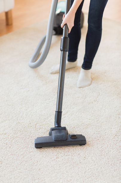 close up of woman legs with vacuum cleaner at home - Photo, Image