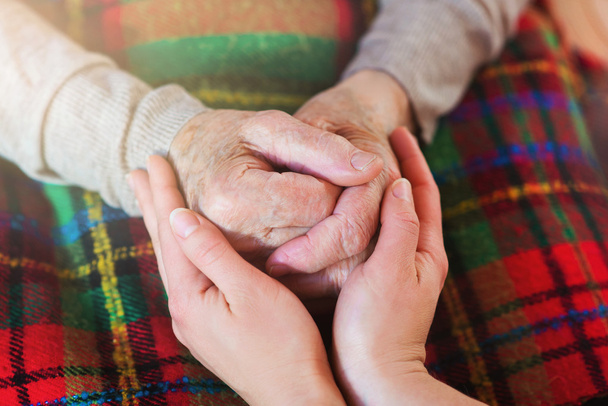 Grandmother and granddaughter holding hands. - 写真・画像