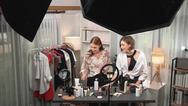 Two influencer partner shoot live streaming vlog video review makeup prim social media or blog. Happy young girl with cosmetics studio lighting for marketing recording session broadcasting online. - Footage, Video