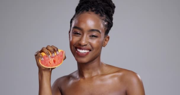 Skincare, wellness és arc fekete nő grapefruit szépség, kozmetikumok vagy előnyök stúdióban. Bőrgyógyászat, spa és portré a személy gyümölcs a természetes, egészséges bőr szürke alapon. - Felvétel, videó