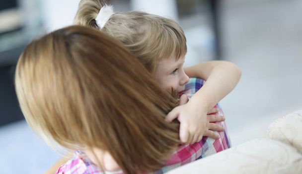 Portrait of mother and daughter hugging, mother comfort little kid, warm precious family moment. Kid spend time with parent. Family relationship concept - 写真・画像