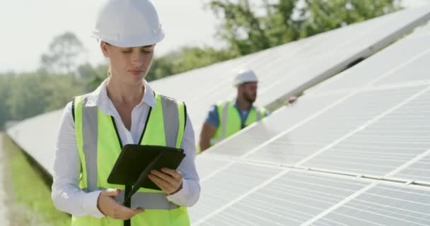 Woman, tablet and solar panels or inspection for energy saving sustainable, environment or safety. Female person, teamwork and pointing for future eco friendly or agriculture, photovoltaic or digital. - Footage, Video