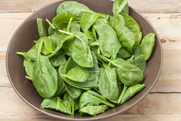 spinach leaves in a brown bowl - Photo, Image