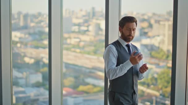 Stressed leader thinking decision tossing ball at cityscape. Pensive bearded man contemplating problem solution resting at panoramic window. Successful banker planning future career development. - Footage, Video