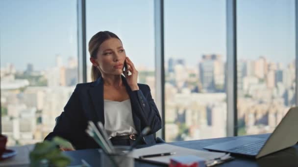 Unhappy worker talking mobile phone in modern office. Worried woman making notes solving problem on cell call at panoramic window. Frustrated financial specialist hearing bad news speaking smartphone. - Footage, Video