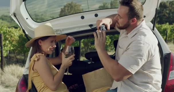 Wine, happy and camera picture of couple on car road trip, summer travel or take memory photo of Argentina holiday journey. SUV, winery farm and people smile for vacation photography in countryside. - Footage, Video