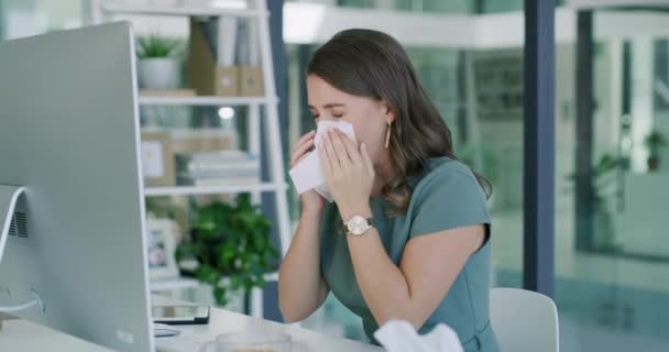 Sick business woman, sneeze and blowing nose by computer for virus, infection or disease at office. Female person or employee with tissue for sinus, illness or bacteria and germs by desk at workplace. - Footage, Video