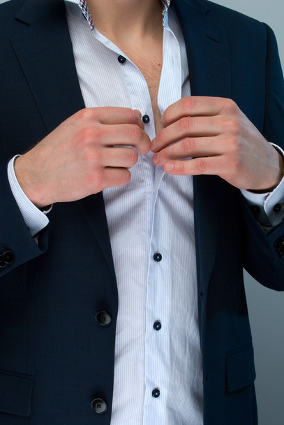 Man adjusting his shirt buttons. - Фото, зображення