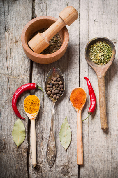 Colorful spices on a wooden background - Valokuva, kuva