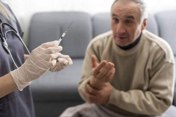 elderly man getting coronavirus vaccine. - Photo, Image