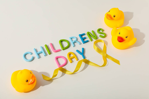 The inscription Children's Day with a yellow ribbon and a toy duck - Photo, Image