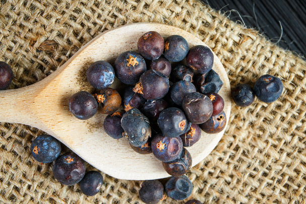 juniper berries on old wooden spoon - Photo, Image