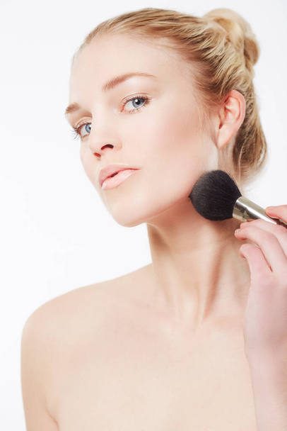 Makeup brush, portrait or model with skincare in studio for beauty or wellness on white background. Makeover, glamour or woman isolated with foundation powder, cosmetics or product for application. - Photo, Image