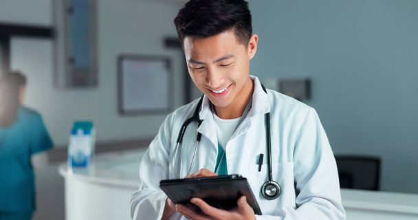 Tablet, healthcare doctor and happy man typing online research, check medicine study and smile for wellness results. Hospital service, happiness and surgeon reading clinic review, feedback or news. - Photo, Image