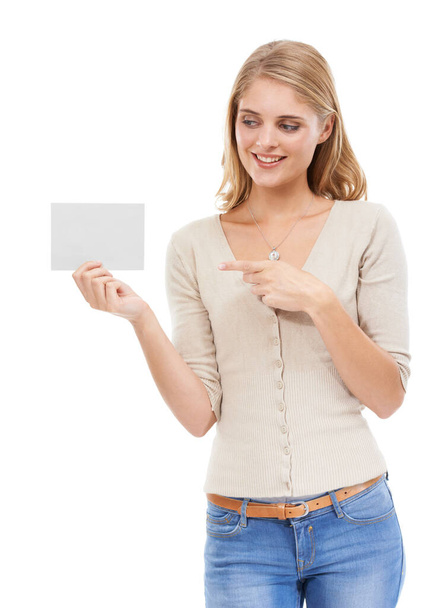 Woman, pointing at card and advertising, presentation or announcement with information on poster on white background. About us, coming soon or sign up with news, marketing or ads with board in studio. - Photo, Image