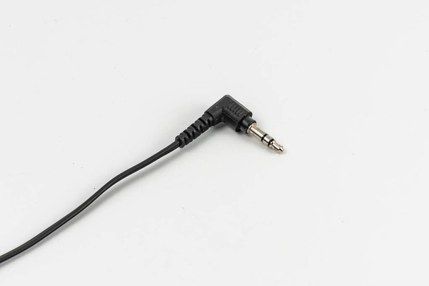 Long black cable of headphones with microjack connector at the end - Photo, Image