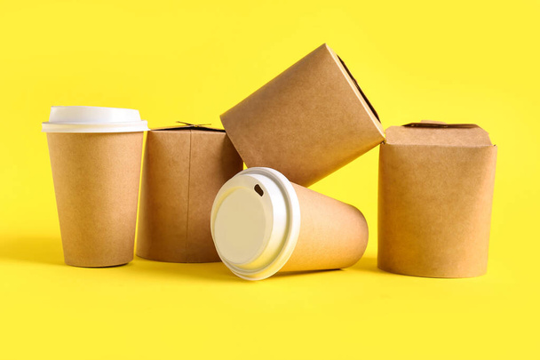 Tasses et boîtes en papier à emporter sur fond jaune - Photo, image