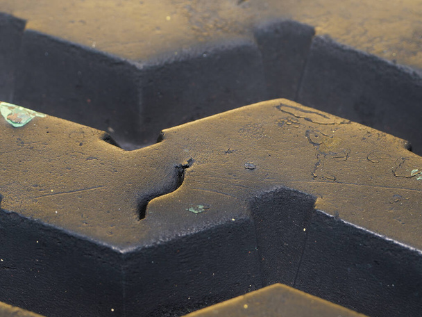 In this detailed close-up photograph, the intricate textures and patterns of a tire's rubber surface come into focus. - Photo, Image