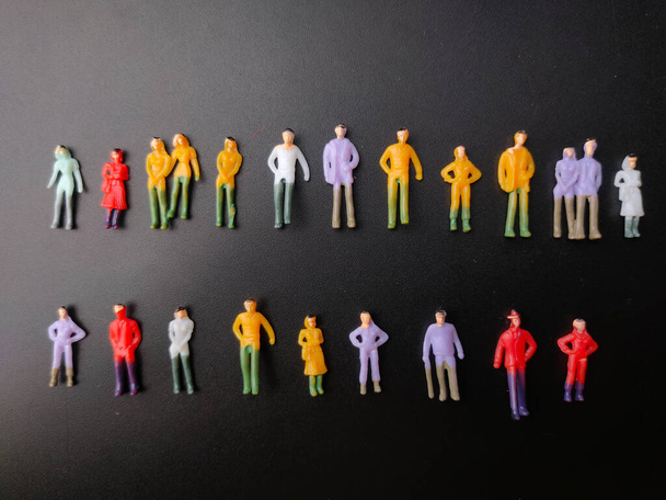 Top view miniature people on a black background. - Photo, Image