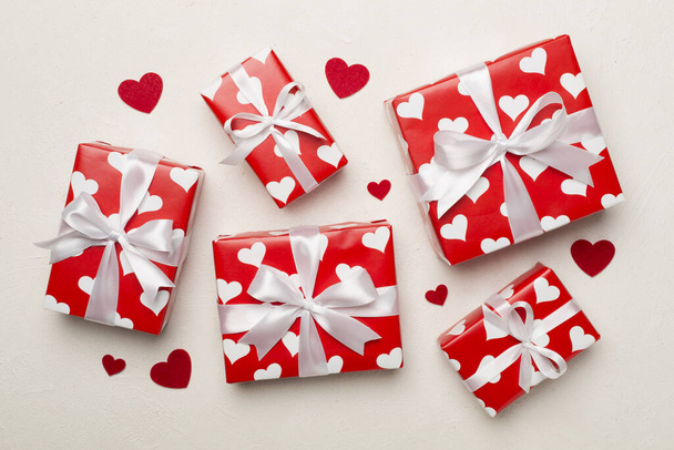Gift boxes with hearts on concrete background, top view - Fotografie, Obrázek
