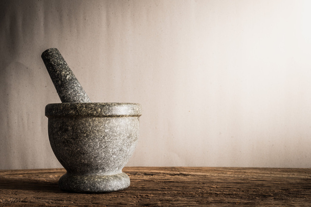 Still life mortar on wooden table - Фото, изображение
