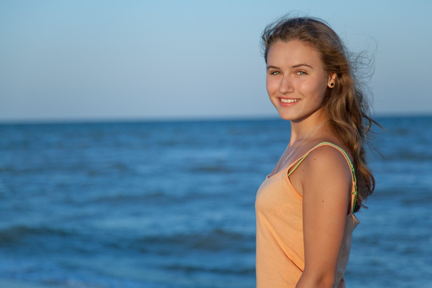 Young beautiful girl on the beach - Фото, зображення