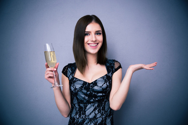 Smiling pretty woman holding glass of champagne - Fotoğraf, Görsel